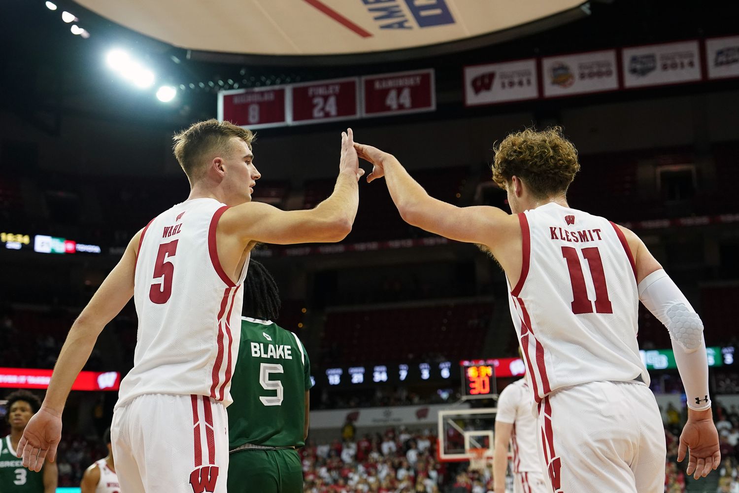 Wisconsin starters Tyler Wahl and Max Klesmit high five after a play against UW-Green Bay.
